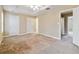 A roomy bedroom with a tray ceiling and neutral walls at 6374 Rockaway Rd, Atlanta, GA 30349