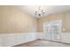 Elegant dining room with wainscoting and French doors to the backyard at 6374 Rockaway Rd, Atlanta, GA 30349