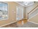 Welcoming foyer with hardwood accents, a staircase, and natural light at 6374 Rockaway Rd, Atlanta, GA 30349