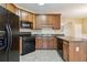 The kitchen boasts wood cabinets, black appliances, and a countertop island at 6374 Rockaway Rd, Atlanta, GA 30349