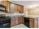 The kitchen features wood cabinetry, a black stove, and an island with countertop space at 6374 Rockaway Rd, Atlanta, GA 30349