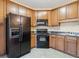 This kitchen showcases wood cabinets and black appliances at 6374 Rockaway Rd, Atlanta, GA 30349