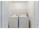 This laundry room features a washer, dryer, and wire shelving at 6374 Rockaway Rd, Atlanta, GA 30349