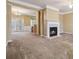 Open-concept living room featuring a fireplace and a view to the dining area at 6374 Rockaway Rd, Atlanta, GA 30349