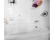 Close-up shot of a white tub with silver faucet and white tiled walls in the bathroom at 10 Perimeter Summit Ne Blvd # 2207, Atlanta, GA 30319