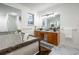 Bathroom featuring a tub with jets, double sinks, and light coming through a window at 1285 Glandor Se Ct, Mableton, GA 30126