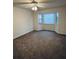 Cozy bedroom featuring neutral carpet, ceiling fan, and bay window at 1285 Glandor Se Ct, Mableton, GA 30126