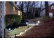Exterior view with landscaped retaining wall with steps leading up to the main house at 1285 Glandor Se Ct, Mableton, GA 30126