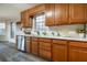 Kitchen with oak cabinets, stainless steel dishwasher, sink, white countertops and view to breakfast nook at 1285 Glandor Se Ct, Mableton, GA 30126
