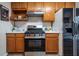 Kitchen showcasing stainless steel appliances, white counters, and natural wood cabinets at 1285 Glandor Se Ct, Mableton, GA 30126