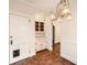 Entryway featuring brick floors and a built-in hutch, complemented by an elegant chandelier at 2876 Alpine Ne Rd, Atlanta, GA 30305