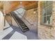 Exterior brick stairway with metal railings and a wood paneled ceiling at 440 Belada Blvd, Sandy Springs, GA 30342
