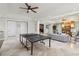 Spacious basement with a ping pong table, living area with fireplace and travertine floors at 440 Belada Blvd, Sandy Springs, GA 30342