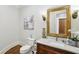 Elegant powder room featuring a decorative mirror, stylish vanity, and marble countertops at 440 Belada Blvd, Sandy Springs, GA 30342