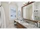 Bright bathroom with granite counters, wood cabinets, framed mirror and plantation shutters at 440 Belada Blvd, Sandy Springs, GA 30342