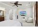 Bright bedroom boasting a ceiling fan, TV, and a cozy seating area with a white chair at 440 Belada Blvd, Sandy Springs, GA 30342