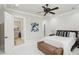 Bright bedroom featuring a ceiling fan, bench, and neutral décor, creating a calming and inviting space at 440 Belada Blvd, Sandy Springs, GA 30342