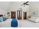 Spacious bedroom with vaulted ceiling, hardwood bookcases and a comfortable seating area at 440 Belada Blvd, Sandy Springs, GA 30342
