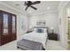 Comfortable bedroom featuring plantation shutters, a ceiling fan, and a cozy bed with stylish pillows at 440 Belada Blvd, Sandy Springs, GA 30342