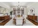 Formal dining room features hardwood floors, wainscoting, updated chandelier and access to the foyer at 440 Belada Blvd, Sandy Springs, GA 30342