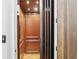 A stylish wooden residential elevator with chrome accents at 440 Belada Blvd, Sandy Springs, GA 30342