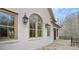 Luxurious home featuring stone exterior with arched windows and manicured landscaping at 440 Belada Blvd, Sandy Springs, GA 30342