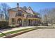 Elegant two-story home with a brick facade, a balcony, a manicured lawn, and iron fencing at 440 Belada Blvd, Sandy Springs, GA 30342