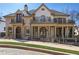 Elegant brick home with a charming front yard, second story terraces, and manicured landscaping at 440 Belada Blvd, Sandy Springs, GA 30342