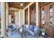 Inviting porch featuring a cozy seating area with stylish furniture and elegant wood and glass doors at 440 Belada Blvd, Sandy Springs, GA 30342
