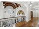 Hallway with hardwood floors, iron railing, and wood beam architectural details at 440 Belada Blvd, Sandy Springs, GA 30342