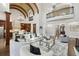 Bright living room with high ceilings, a fireplace, large windows, comfortable seating and view to kitchen at 440 Belada Blvd, Sandy Springs, GA 30342