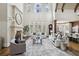 Bright living room with high ceilings, a fireplace, large windows, and comfortable seating at 440 Belada Blvd, Sandy Springs, GA 30342