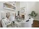 Bright living room with high ceilings, a fireplace, large windows, and comfortable seating and view to upstairs at 440 Belada Blvd, Sandy Springs, GA 30342