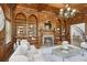 Elegant living room with custom wood bookshelves, fireplace, and large windows at 440 Belada Blvd, Sandy Springs, GA 30342