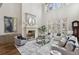 Bright living room with high ceilings, a fireplace, large windows, and comfortable seating at 440 Belada Blvd, Sandy Springs, GA 30342