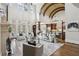 Bright living room with fireplace, floor to ceiling windows, cathedral ceilings and open floor plan to the kitchen at 440 Belada Blvd, Sandy Springs, GA 30342