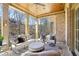 Covered patio with stone flooring and wood ceiling features an outdoor seating area with views of the backyard at 440 Belada Blvd, Sandy Springs, GA 30342