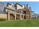 Beautiful brick home featuring a covered patio and second-story balcony overlooking a spacious, grassy backyard at 440 Belada Blvd, Sandy Springs, GA 30342