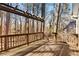 Inviting wooden deck with pergola, surrounded by a wooded landscape at 6165 Picketts Nw Rdg, Acworth, GA 30101