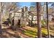 Backyard view features a deck, stairs, and lush greenery, and mature trees at 6165 Picketts Nw Rdg, Acworth, GA 30101