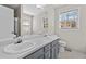 Bathroom featuring double sinks, a large mirror, and natural light from two windows at 6165 Picketts Nw Rdg, Acworth, GA 30101