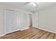 Bedroom features hardwood floors, a ceiling fan, and a large closet at 6165 Picketts Nw Rdg, Acworth, GA 30101