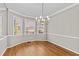 Inviting dining room featuring hardwood floors, large windows, and chandelier lighting at 6165 Picketts Nw Rdg, Acworth, GA 30101