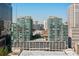 Complex aerial shot showing the buildings, surrounding landscape, and shared community pool and parking at 943 Peachtree Ne St # 2009, Atlanta, GA 30309
