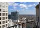 Expansive city view from a high-rise balcony, showcasing the urban landscape and clear blue skies at 943 Peachtree Ne St # 2009, Atlanta, GA 30309