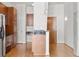 Well-lit kitchen with wood cabinetry, stainless steel appliances, and modern pendant lighting over breakfast bar at 943 Peachtree Ne St # 2009, Atlanta, GA 30309