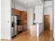 The kitchen has stainless steel appliances, wooden cabinets, and a view of the snack bar with modern lighting at 943 Peachtree Ne St # 2009, Atlanta, GA 30309