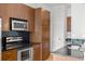 Modern kitchen features stainless steel appliances, dark countertops, and wooden cabinets at 943 Peachtree Ne St # 2009, Atlanta, GA 30309