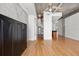 Bright, open living room with hardwood floors, exposed concrete ceiling, and a view into the kitchen at 943 Peachtree Ne St # 2009, Atlanta, GA 30309