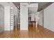 Open living room space featuring hardwood floors, recessed lighting, exposed concrete, and a view into the kitchen at 943 Peachtree Ne St # 2009, Atlanta, GA 30309